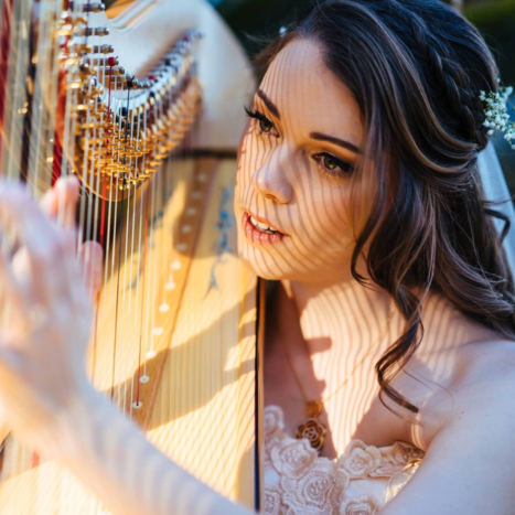 A musical bride enjoys playing Bart's harp following her ceremony
