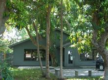 Custom-built bungalow-style home situated within a historic mango grove. Recently renovated inside and out. Century-old trees capture the seabreeze and completely shade front and back yards