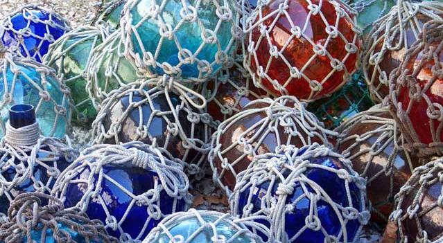 Blue, red and green glass balls wrapped in cotton netting