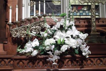 One bookend altar arrangement done in whites and greens with orchids, fuji mums, casa blancas, hydrangea, and snapdragons