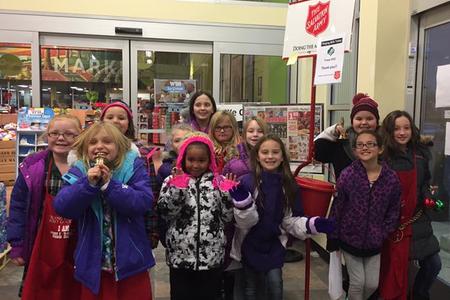 girl scouts ringing salvation army bell