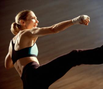 Fitness teacher performing a Kick boxing class for weight loss and body conditioning
