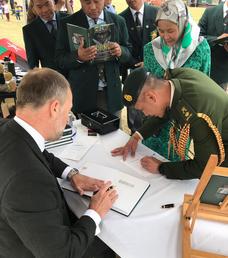 Signing a copy of the new Gurkha book for the Brunei Defence Attache