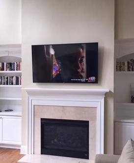 flat screen 4k ultra hd tv hung over fireplace in charlotte nc