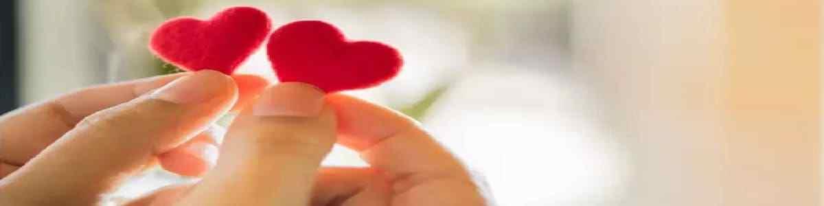 a person is holding up a small Felt Fabric heart in each hand, wondering if they will ever find their soulmate, Spell To Attract True Love.
