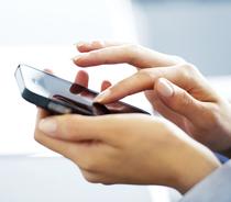 Woman holding a smart phone in her left hand and scrolling down the front screen with her right index finger.