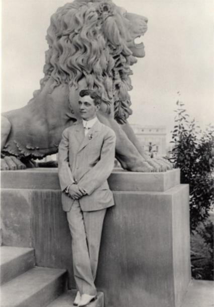 Edward Gardner Lewis posed for this photograph on the steps of the Woman's Magazine Building, next to William Bailey's lion sculpture. The Art Academy Building is just visible on the right.