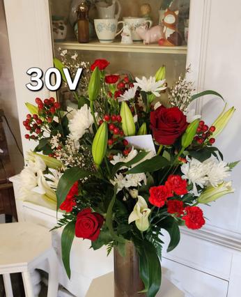 classic, classy, formal, simple valentines day flower vase arrangement boquet with deep dark red roses, lovely pink daisies, closed lillies, small bright red carnations with other flowers for variety