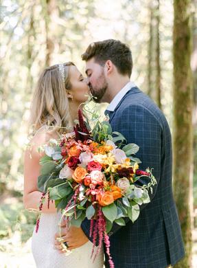 colorful wedding bouquet - happy smiling couple