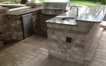 Outdoor kitchen with sink, grill and fridge