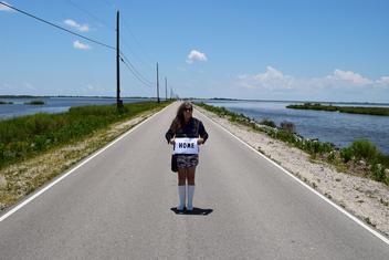 Dawn DeDeaux organized a stand-in event for 1000 people on the last road to Isle de St Charles, Louisiana, an island soon to sink into the Gulf of Mexico, to draw world attention to the fastest eroding land mass in the World just outside of New Orleans.