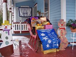 Image of Porch of the Wedgwood Inn during Holidays. Sleigh with gifts on porch.