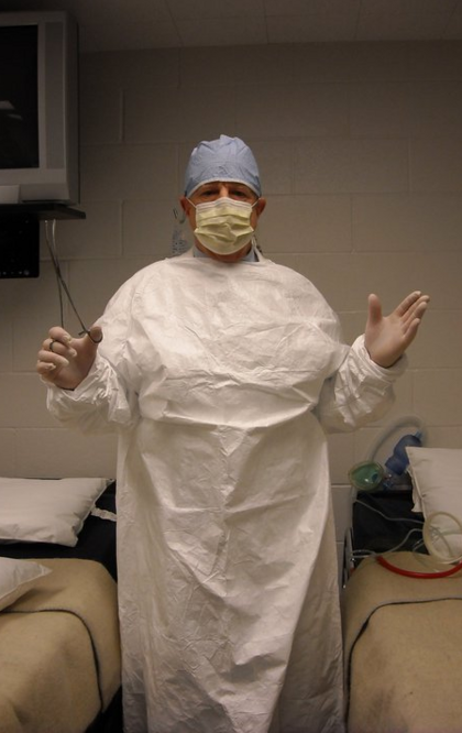 Dr. Johnson in surgical gown and surgery instruments ready to operate