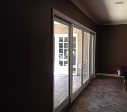 Picture of a newly installed whole wall sliding glass door to the backyard. Double sliding door, one door slides to the left while one door slides to the right.