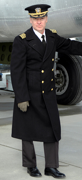 WW2 US Navy commander in winter overcoat and dark blue visor cap