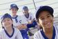 4 Young boys and girls in baseball uniforms smiling like they are having fun
