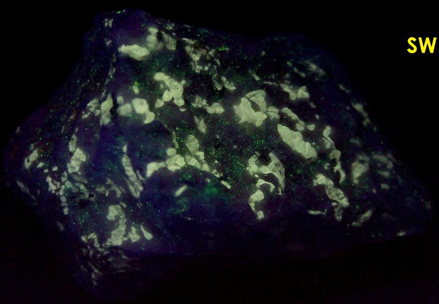 fluorescing FLUOBORITE, CHONDRODITE, PYRITE, CALCITE - Lime Crest Quarry (Lime Crest-Southdown Quarry), Sparta Township, Sussex County, New Jersey, USA