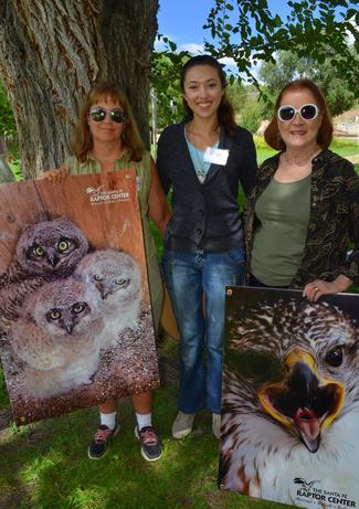 Volunteers with photos of Raptors