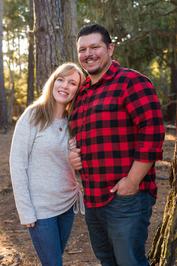 couple portrait in the forest wife head on husbands shoulder who is wearing red plaid shirt taken by Monterey Bay couples photographer
