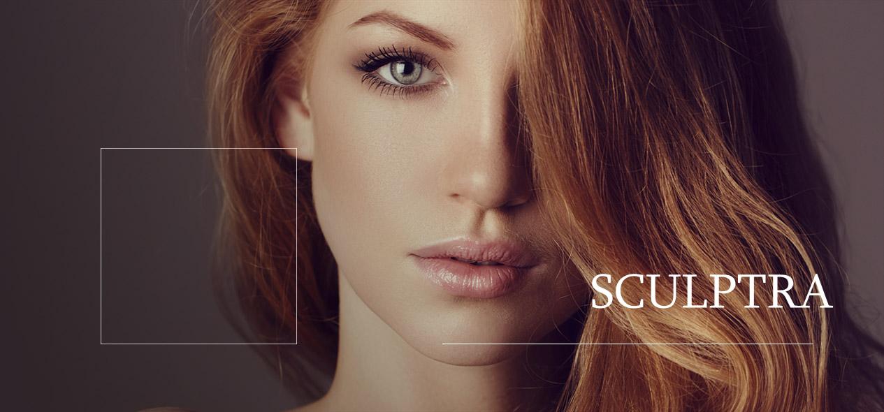 Woman with red hair looking into camera. Find information about the collagen stimulator Sculptra down below!