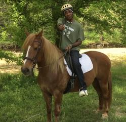 Colby's Army photo of a young man riding English on a chestnut horse