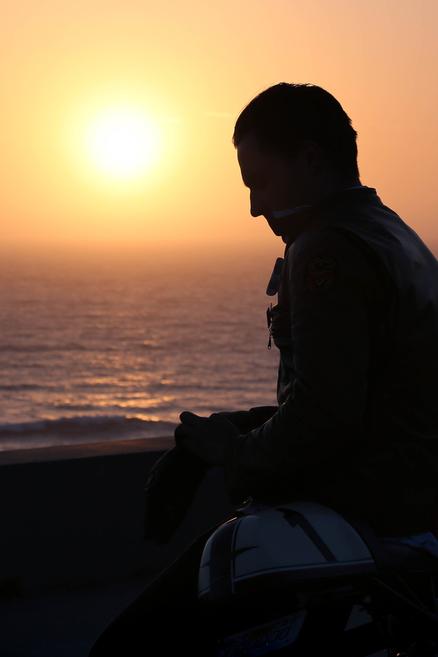 young man shadow over california coast ocean yellow orange sunset