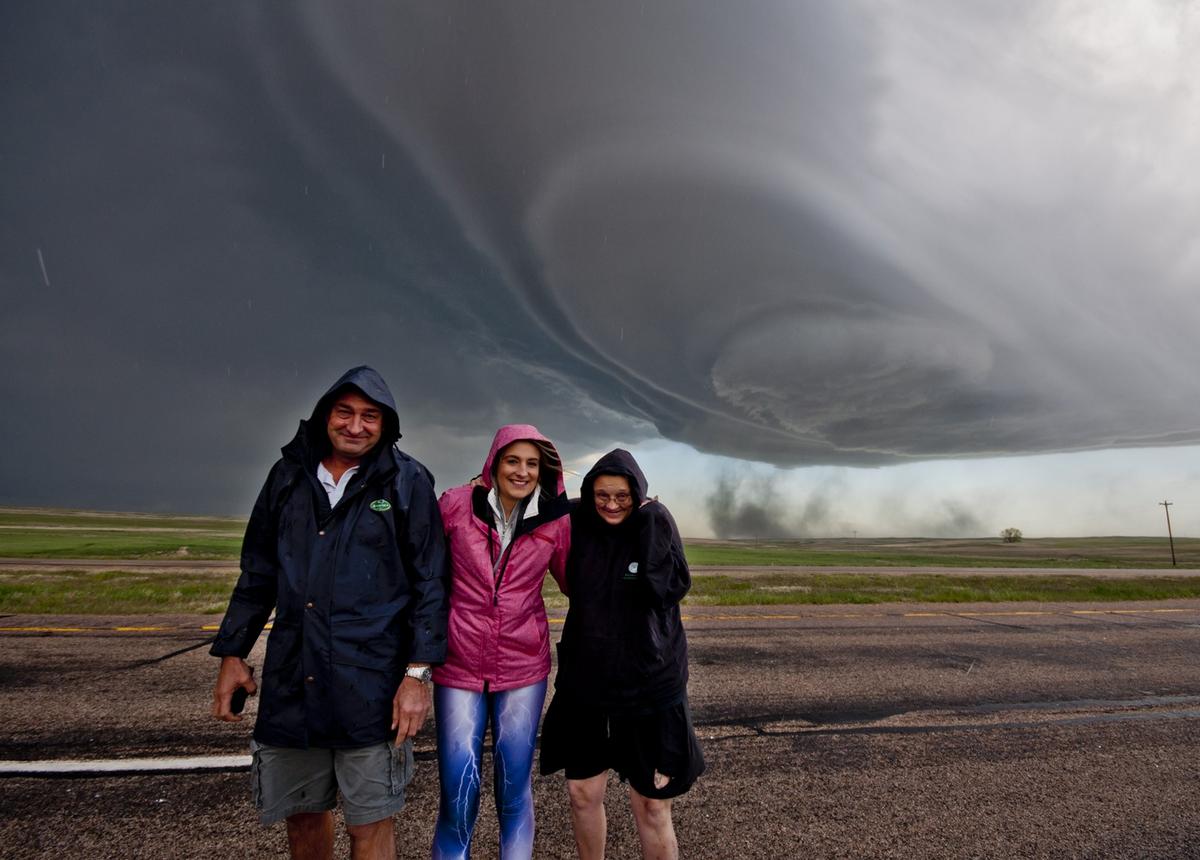 Tornado forming behind storm chasing tour guests