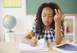 A young girl learning to read after receiving eye treatments in Tarrytown, NY.