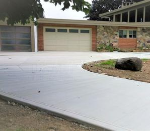 Broom finish concrete driveway with extension, turn around, and parking pad.