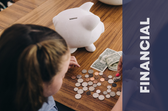 Little girl counting money from her piggy bank