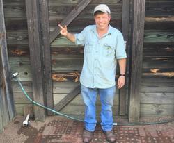 Colby's Army photo of a man outside a barn standing on a brick walkway