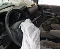 crashed automobile interior with airbags deployed