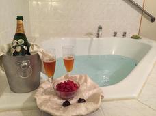 Closeup of whirlpool tub with bottle of champagne, glasses and fresh berries in one of the whirlpool tub suites at the Wedgwood Inn, New Hope, PA
