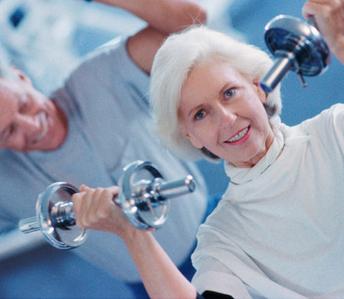 Mature couple weight lifting in a health center