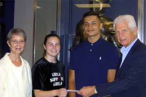 Diana Hite (left) and Carl Linden (right) present Grace Taylor, BHS ASB Treasurer and Troy Saunders, ASB President with a check for $2500.