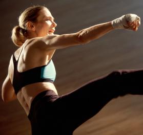 Fitness teacher performing a Kick boxing class for weight loss and body conditioning