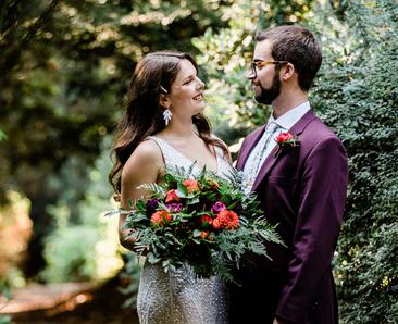 A just married couple holding hands - with large flower bouquet