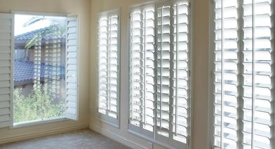 white interior shutters letting some sunshine into the living room
