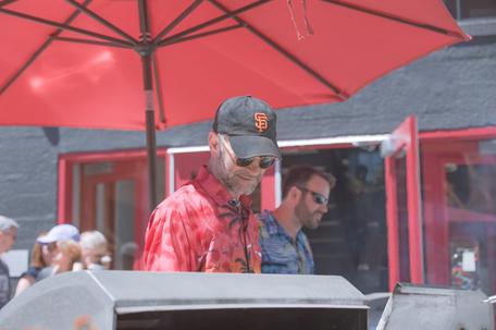 outdoors barbecue middle age man with sunglasses and san francisco giants cap