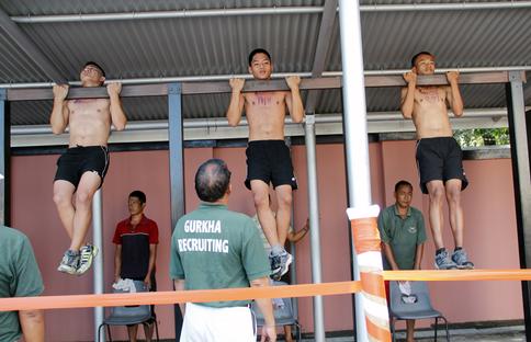 Potential Gurkhas doing pull-ups during recruit selection in Nepal