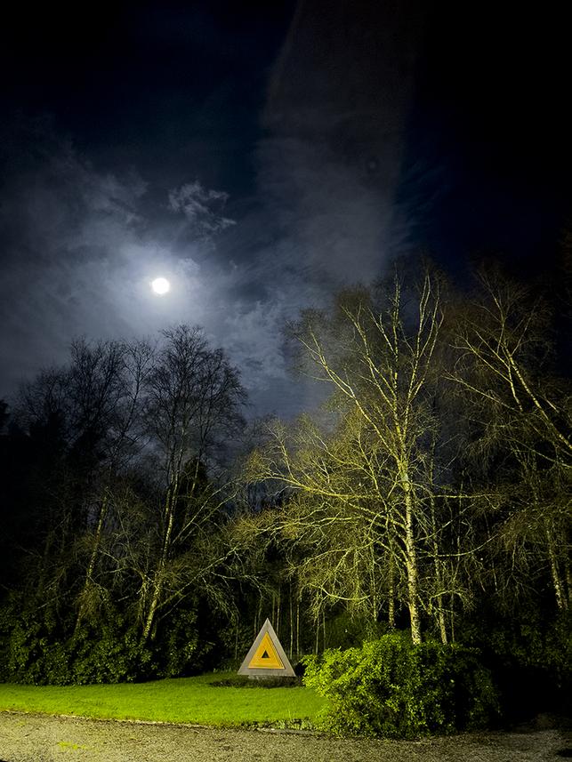 sculpture with full moon background.