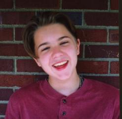Colby's Army photo of Colby Keegan as a teen, smiling in a red shirt