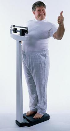 Overweight mature man on top of a weight scale