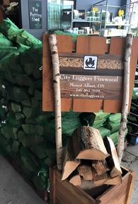 City Loggers firewood bags being sold in a storefront shop