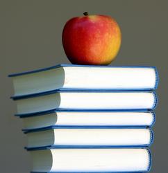 Image of a stack of books with an apple sat on top