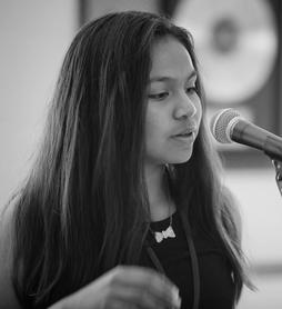 Teen girl singing into a microphone