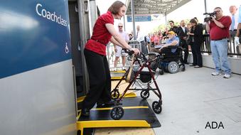 woman using new bridge to exit train