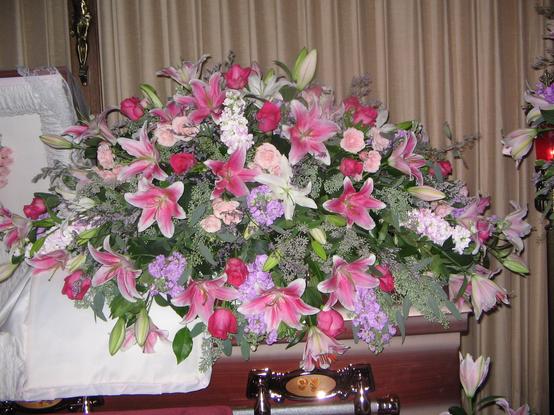 Spray in pinks and lavenders with roses, stock snapdragons, stargazers, spray roses, seeded eucalyptus, and Limonium