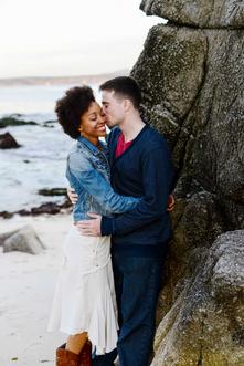 couple embracing man kissing woman's cheek beach photo Monterey Bay couples engagement photographer