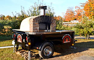 An outdoor wood burning pizza oven that uses firewood